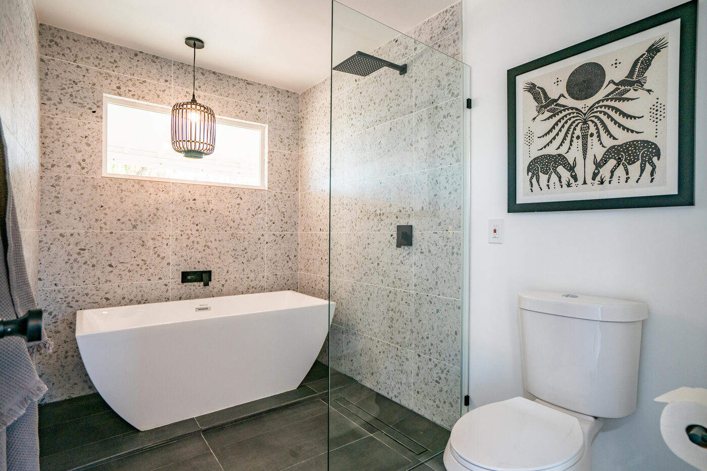 The ADU bathroom, a terrazzo wet room with a soaking tub