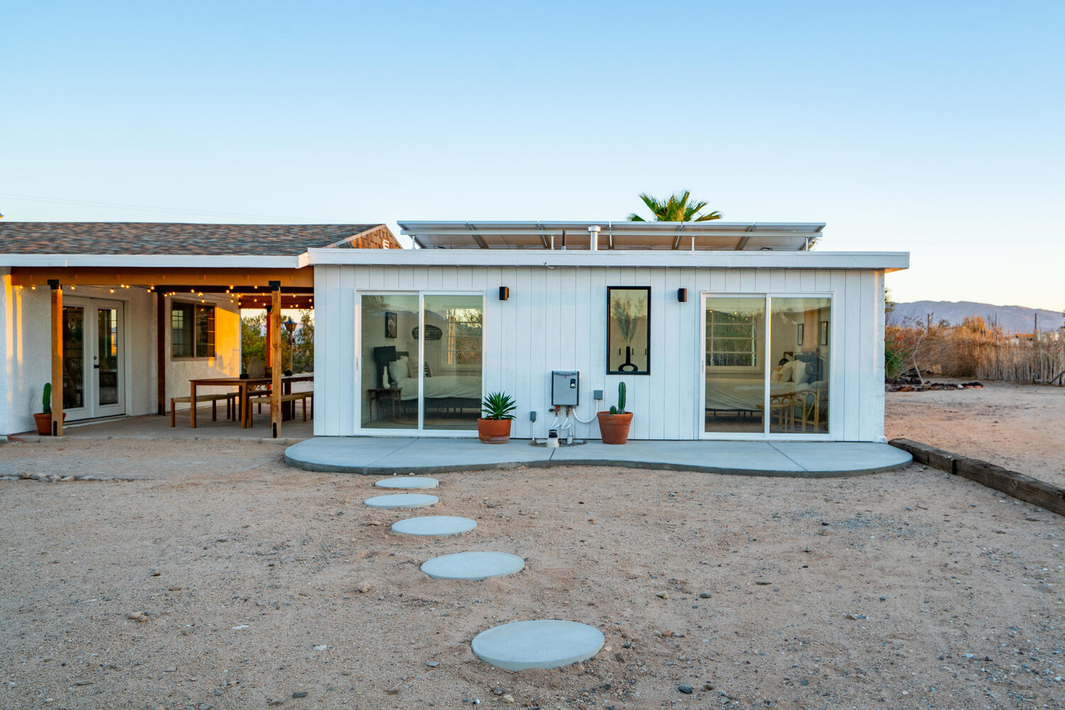 The converted-garage ADU from the rear, with a new poured-concrete patio off the sliding doors